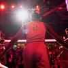 A basketball players enters the court.