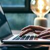 An image of hands typing on a laptop